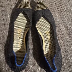 Rothy's The Point flats in black with a gold houndstooth cap toe